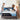 A couple making their bed with a Serta Antarctic mattress featuring a black and light blue border with All-Night Cooling Cooltex branding, on a grey upholstered bed frame