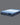 Full angled view of Serta Classic Latex mattress displaying soft blue plush tufted top and deep navy blue floral-patterned base with Classic Latex brand label on grey background