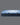 Side profile view of Serta Classic Latex mattress showing soft blue plush pillow-top surface and deep navy blue floral tie-dye patterned base border on a grey background