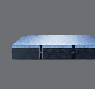 Side profile view of Serta Classic Latex mattress showing soft blue plush pillow-top surface and deep navy blue floral tie-dye patterned base border on a grey background