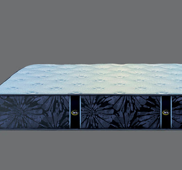 Side profile view of Serta Classic Plus mattress showing light blue quilted top surface and navy blue floral-pattern border on a grey background