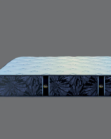 Side profile view of Serta Classic Plus mattress showing light blue quilted top surface and navy blue floral-pattern border on a grey background