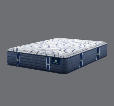 Full angled view of Serta iComfort mattress displaying white and navy blue swirl-patterned pillow-top and deep navy blue quilted base with iComfort brand label