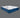 Full angled view of the Serta iLatex mattress displaying its plush white tufted top and navy blue quilted sides with wave stitch detailing