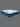 Full angled view of the Serta iLatex mattress displaying its plush white tufted top and navy blue quilted sides with wave stitch detailing