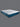 Angled full view of the Serta iPedic mattress displaying its white and blue striped top panel with teal quilted side border