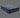 Angled view of Serta Perfect Sleeper Hybrid mattress displaying bold navy and grey floral radial-patterned pillow-top surface and solid navy blue base with brand label