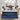 Happy family with two children playing on a Serta Perfect Sleeper mattress with white dash-quilted top and blue oval-patterned border on a navy upholstered bed frame