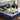 Couple sleeping comfortably on a Serta PerfectSpine mattress with blue wave-pattern fabric on a wooden bed frame in a modern bedroom